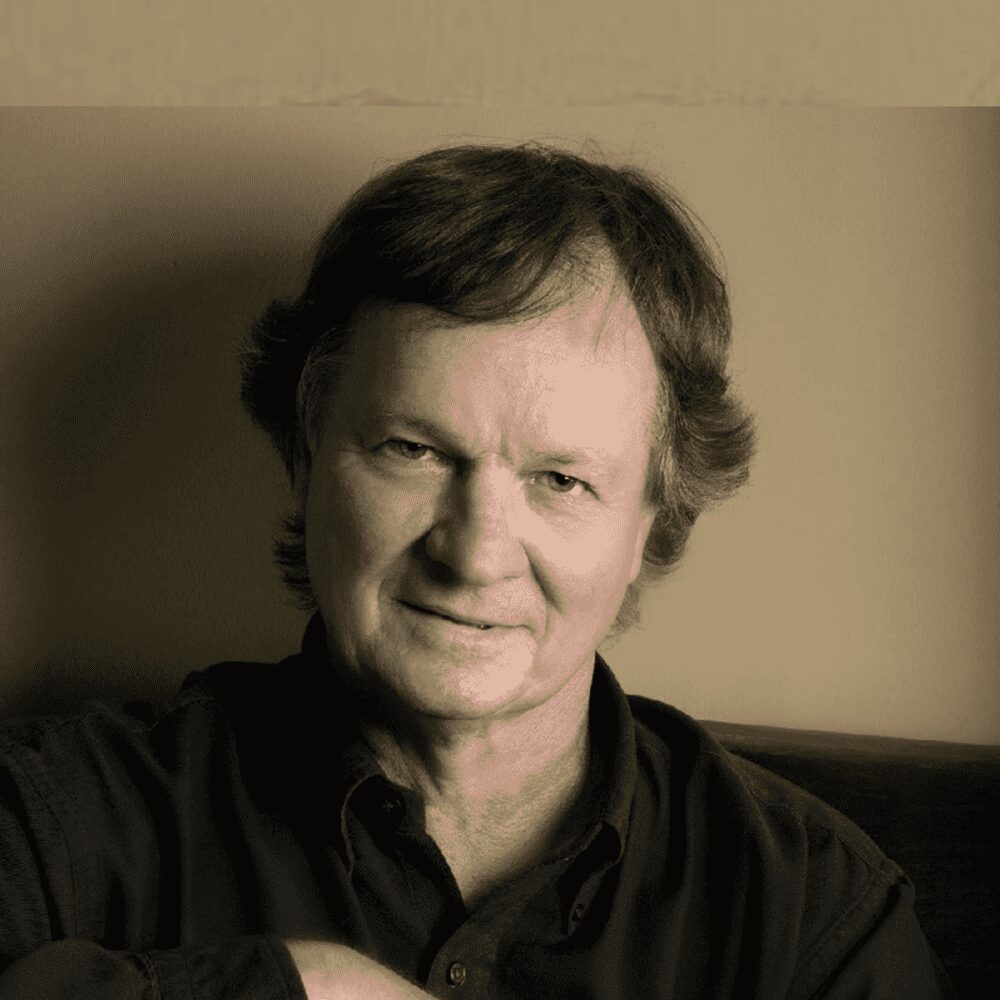 Portrait of a middle-aged man with a gentle smile in a sepia tone.