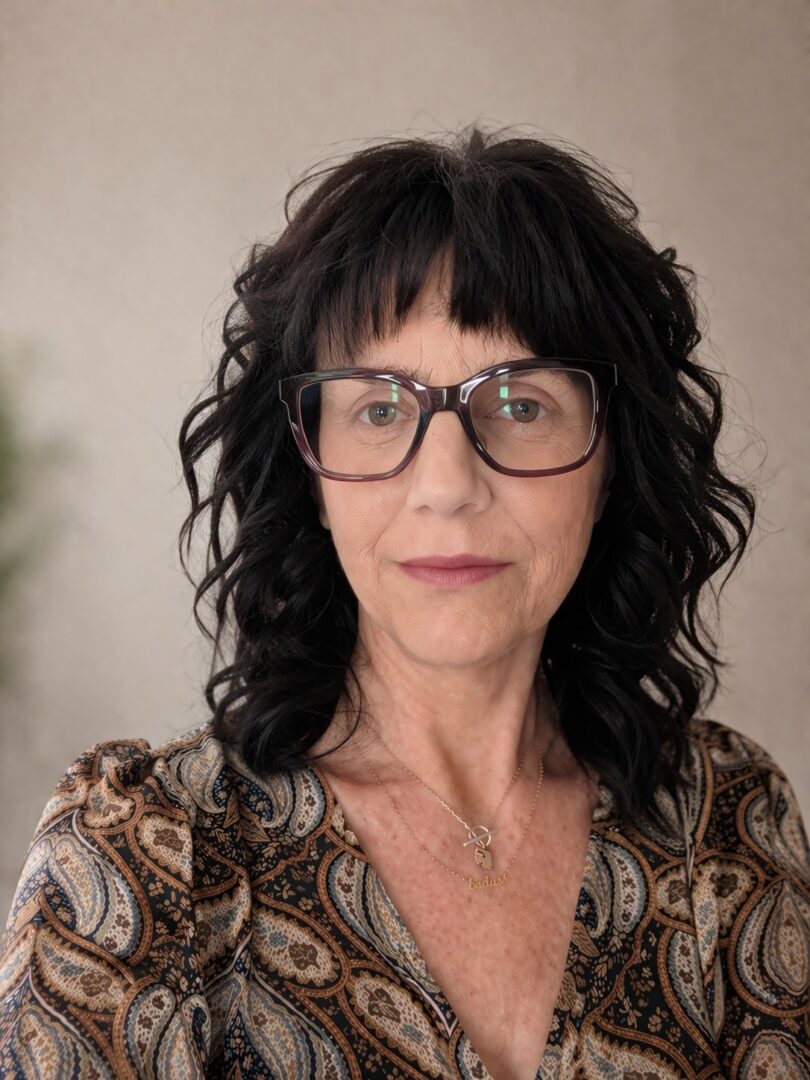 Woman wearing glasses and patterned blouse