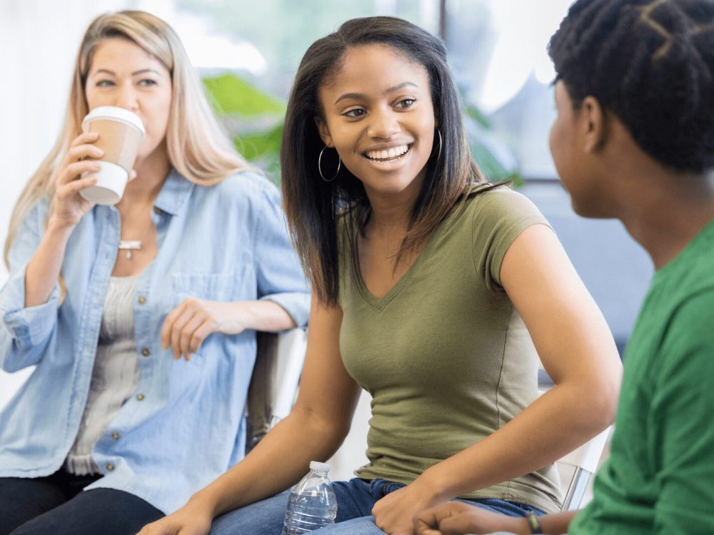 A group of young adults enjoying a friendly conversation.